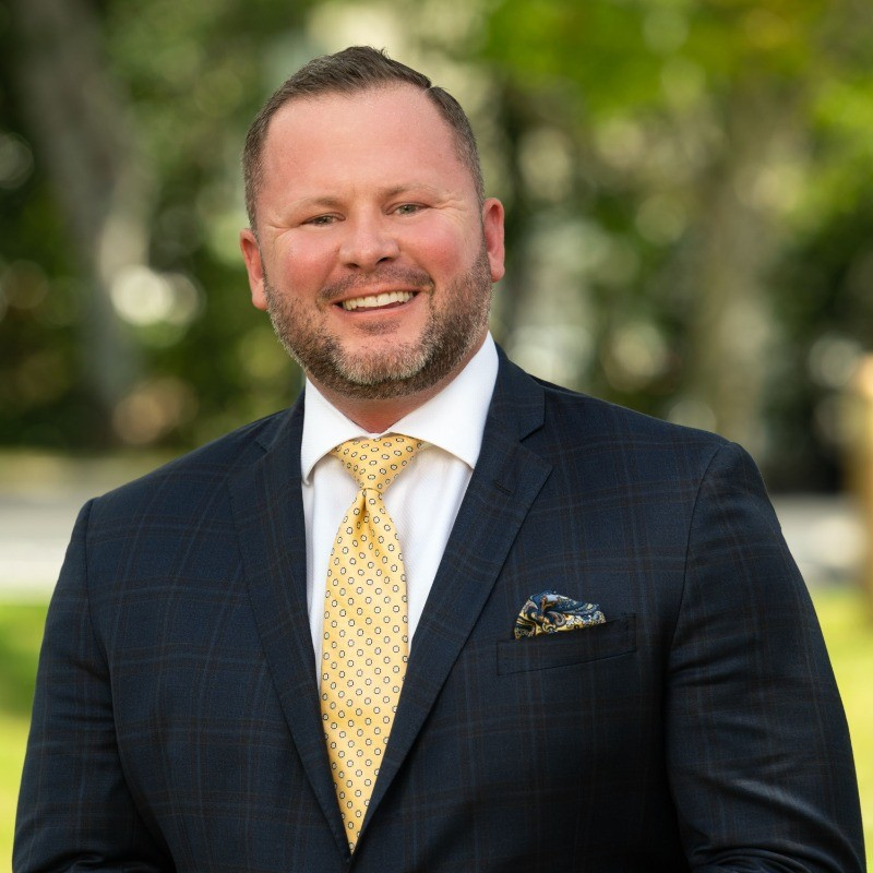 Charley, a wealth advisor in Naples, FL, pictured providing transparent financial guidance.